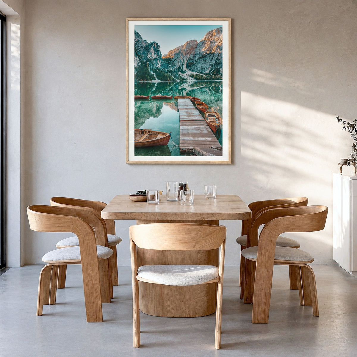 Dolomites Photo No 2 Poster in a natural wood frame, hanging in a dining room, white border