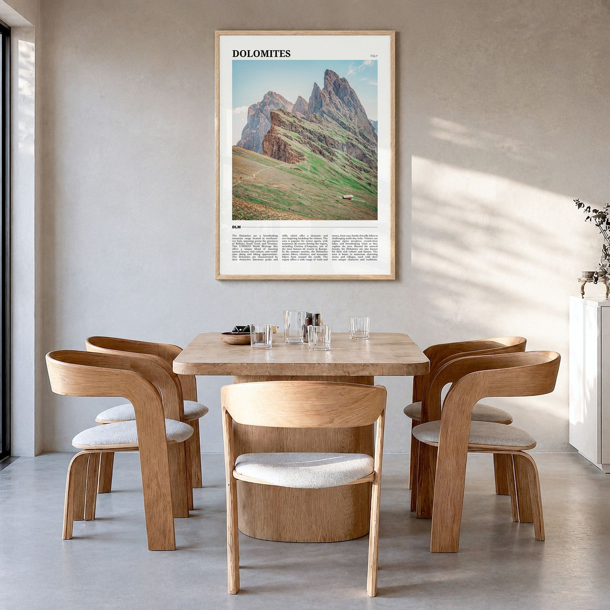 Dolomites Travel Poster in a natural wood frame, hanging in a dining room