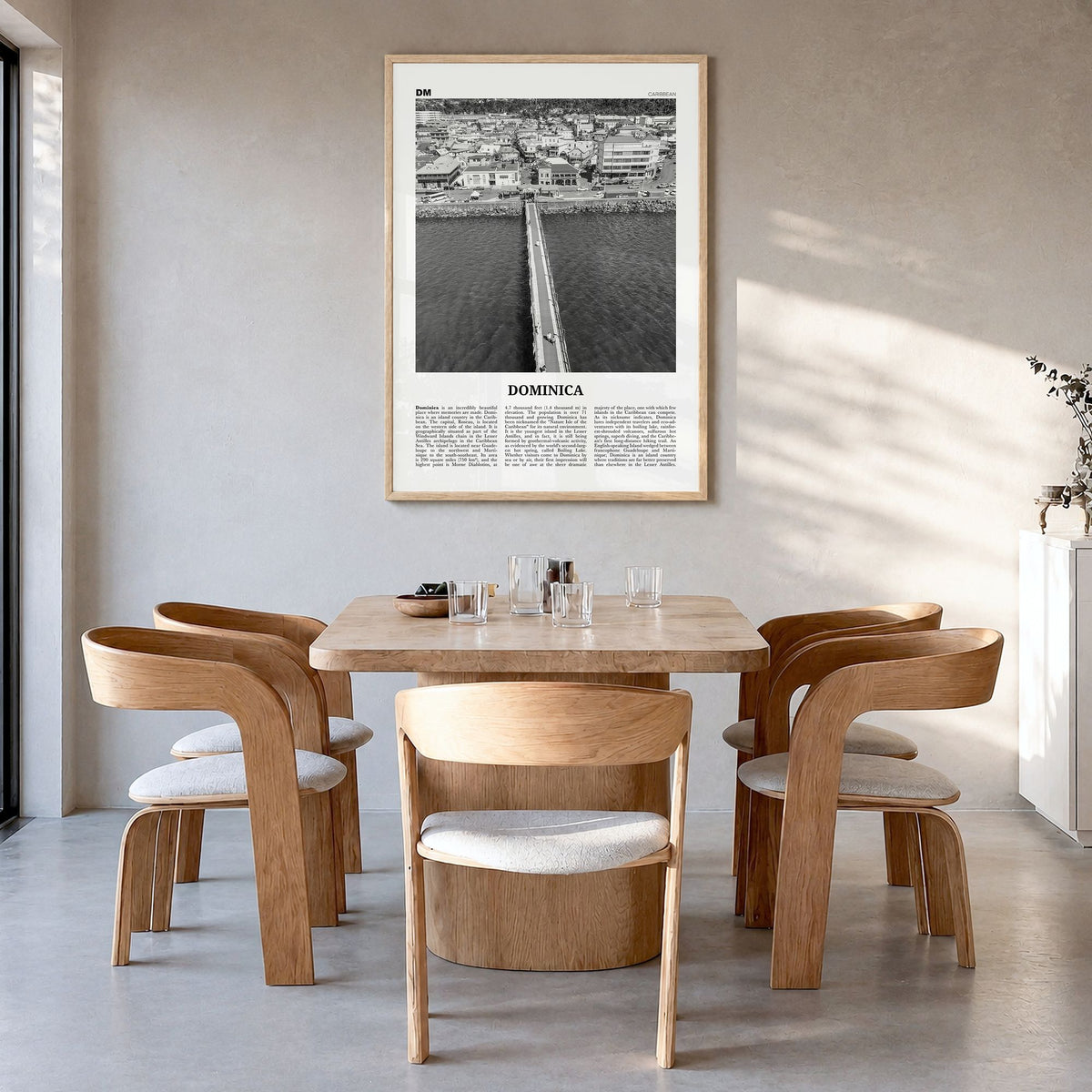 Dominica Newspaper Poster in a natural wood frame, hanging in a dining room