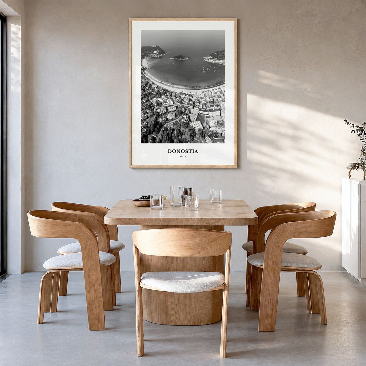 Donostia Classic Poster in a natural wood frame, hanging in a dining room