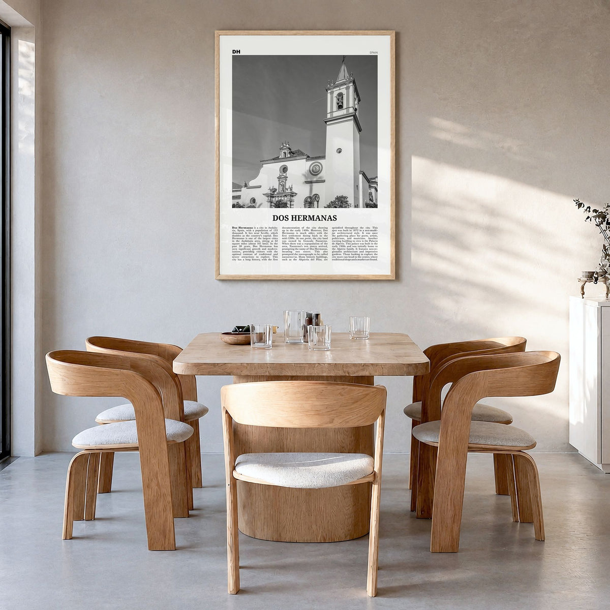 Dos Hermanas Newspaper Poster in a natural wood frame, hanging in a dining room