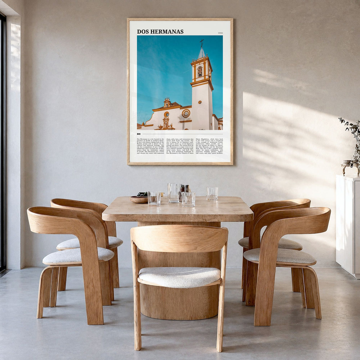 Dos Hermanas Travel Poster in a natural wood frame, hanging in a dining room