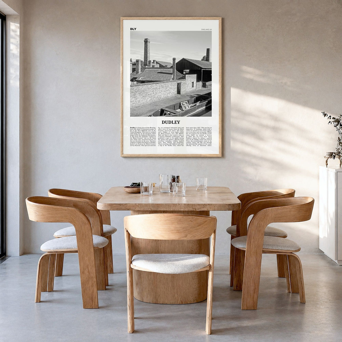 Dudley Newspaper Poster in a natural wood frame, hanging in a dining room