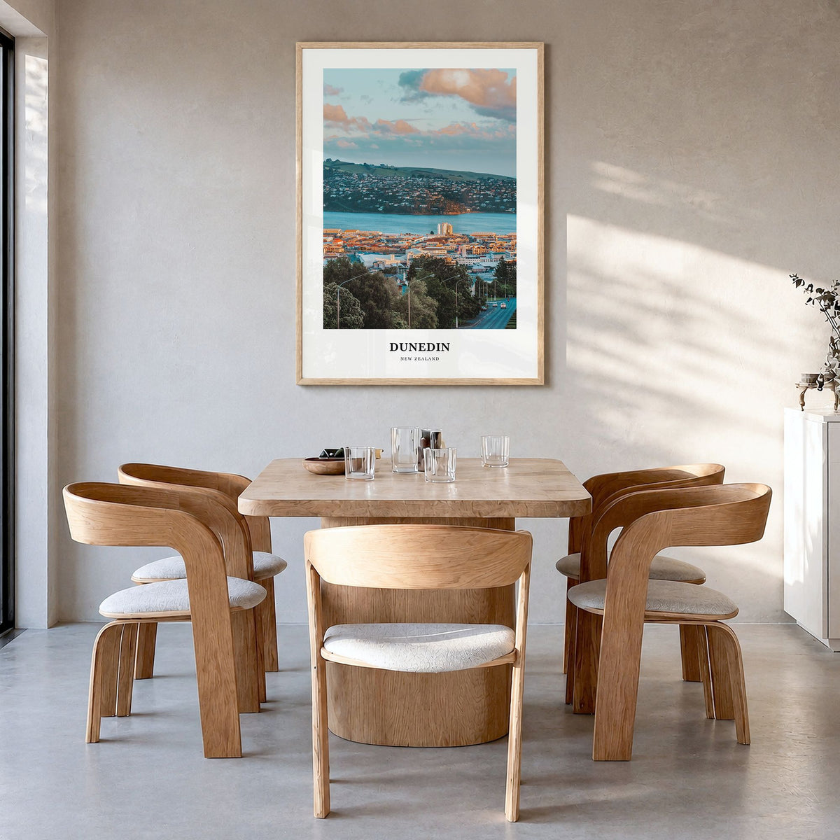 Dunedin Classic No 1 Poster in a natural wood frame, hanging in a dining room