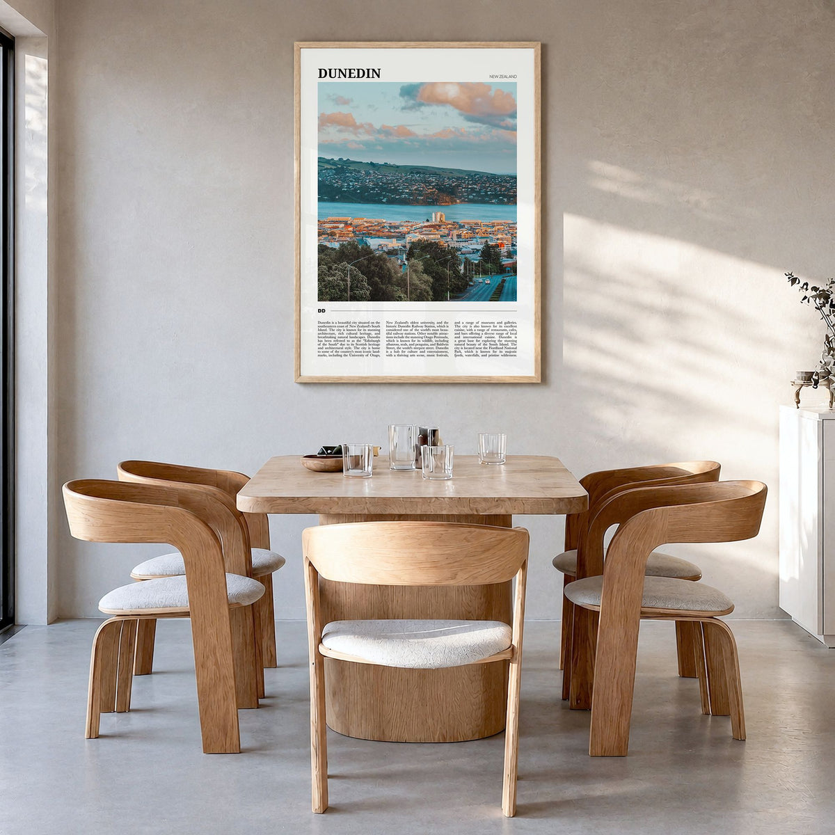 Dunedin Travel No 1 Poster in a natural wood frame, hanging in a dining room