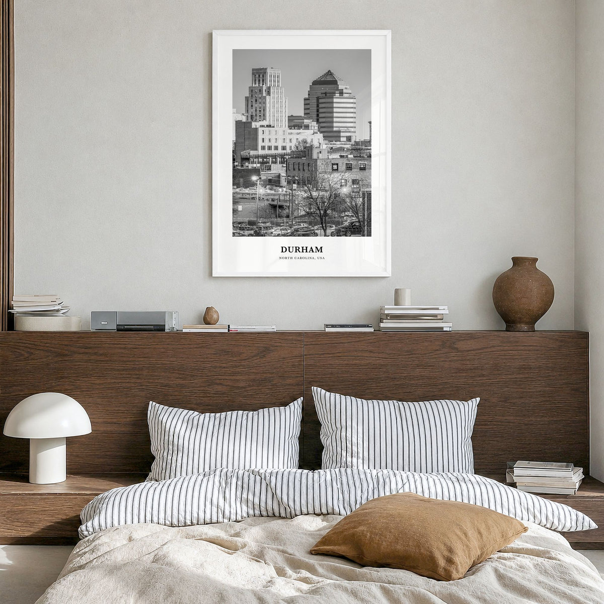 Durham, North Carolina Classic Poster in a white wood frame, hanging in a bedroom