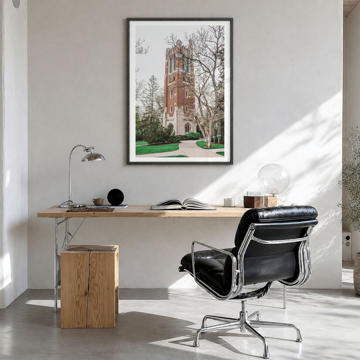 East Lansing Photo Poster in a black wood frame, hanging in a bright home office, white border