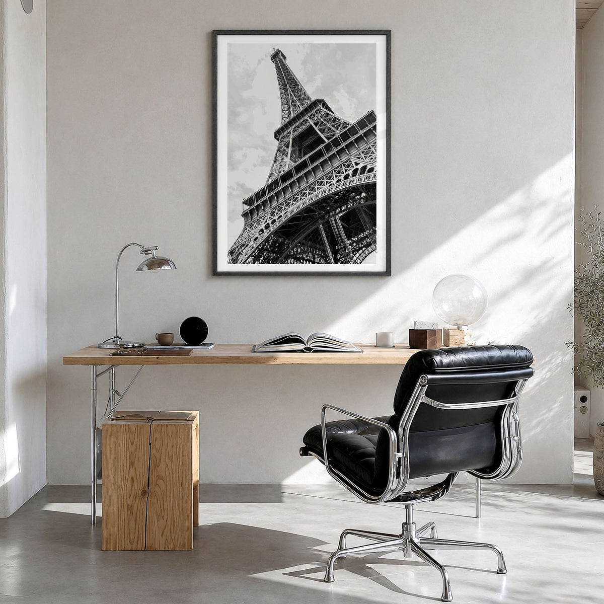 Eiffel Tower Photo Poster in a black wood frame, hanging in a bright home office, white border