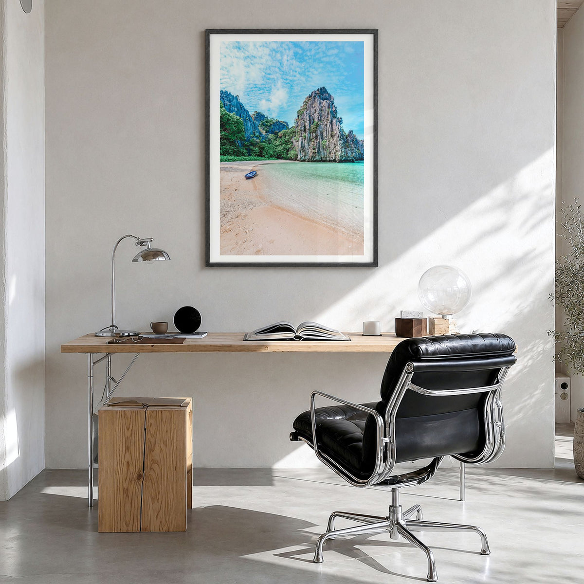 El Nido Photo Poster in a black wood frame, hanging in a bright home office, white border