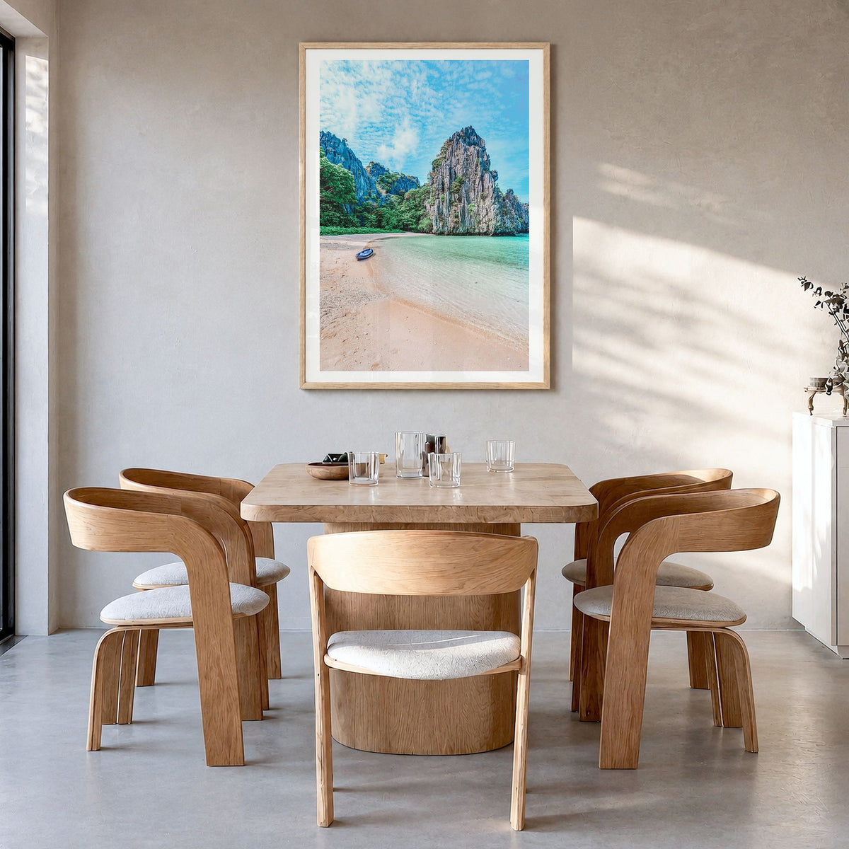 El Nido Photo Poster in a natural wood frame, hanging in a dining room, white border