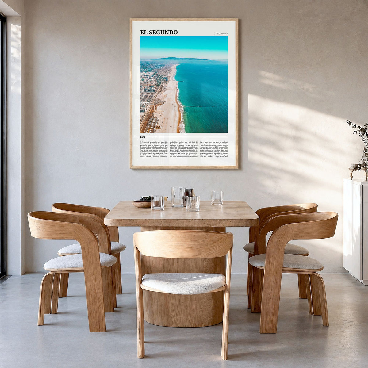 El Segundo Travel Poster in a natural wood frame, hanging in a dining room