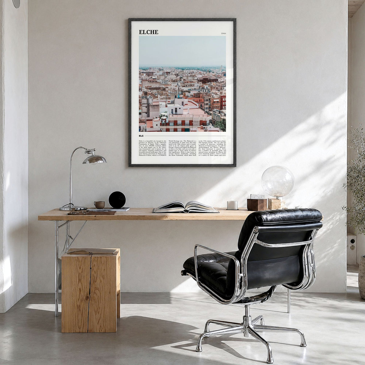 Elche Travel Poster in a black wood frame, hanging in a bright home office