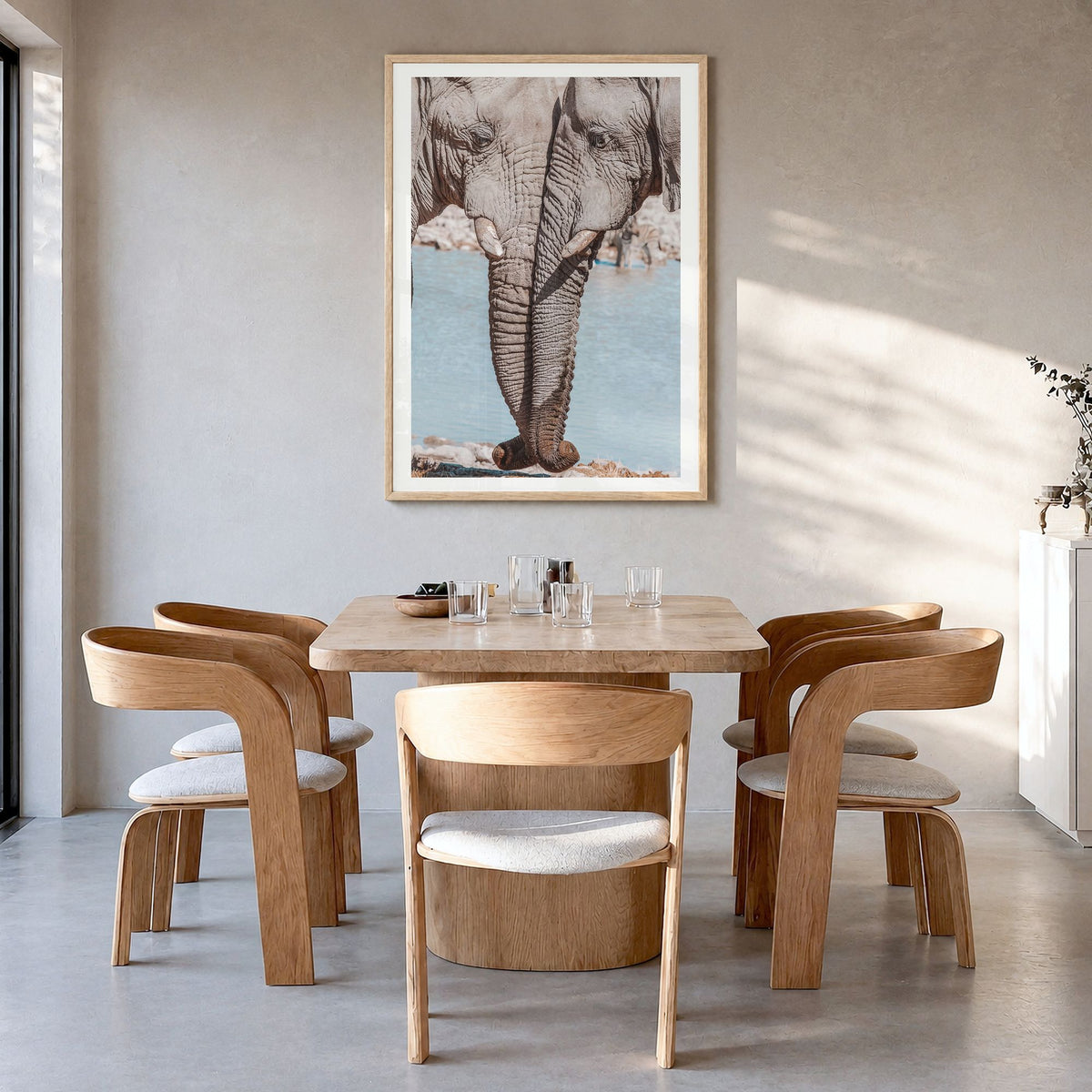 Elephant Couple Photo Poster in a natural wood frame, hanging in a dining room, white border