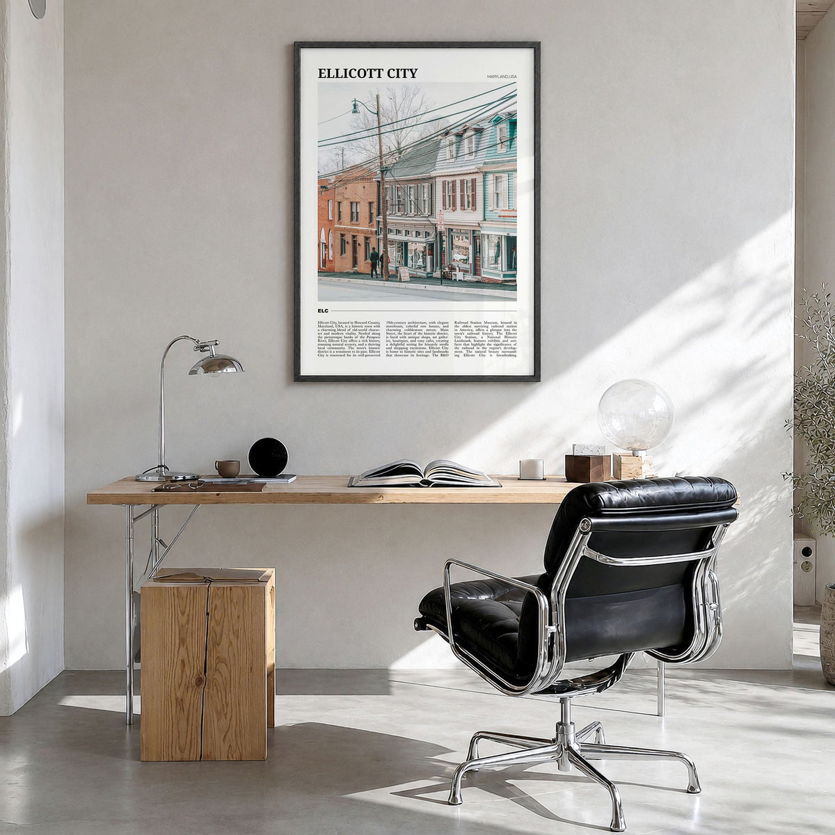 Ellicott City Travel Poster in a black wood frame, hanging in a bright home office