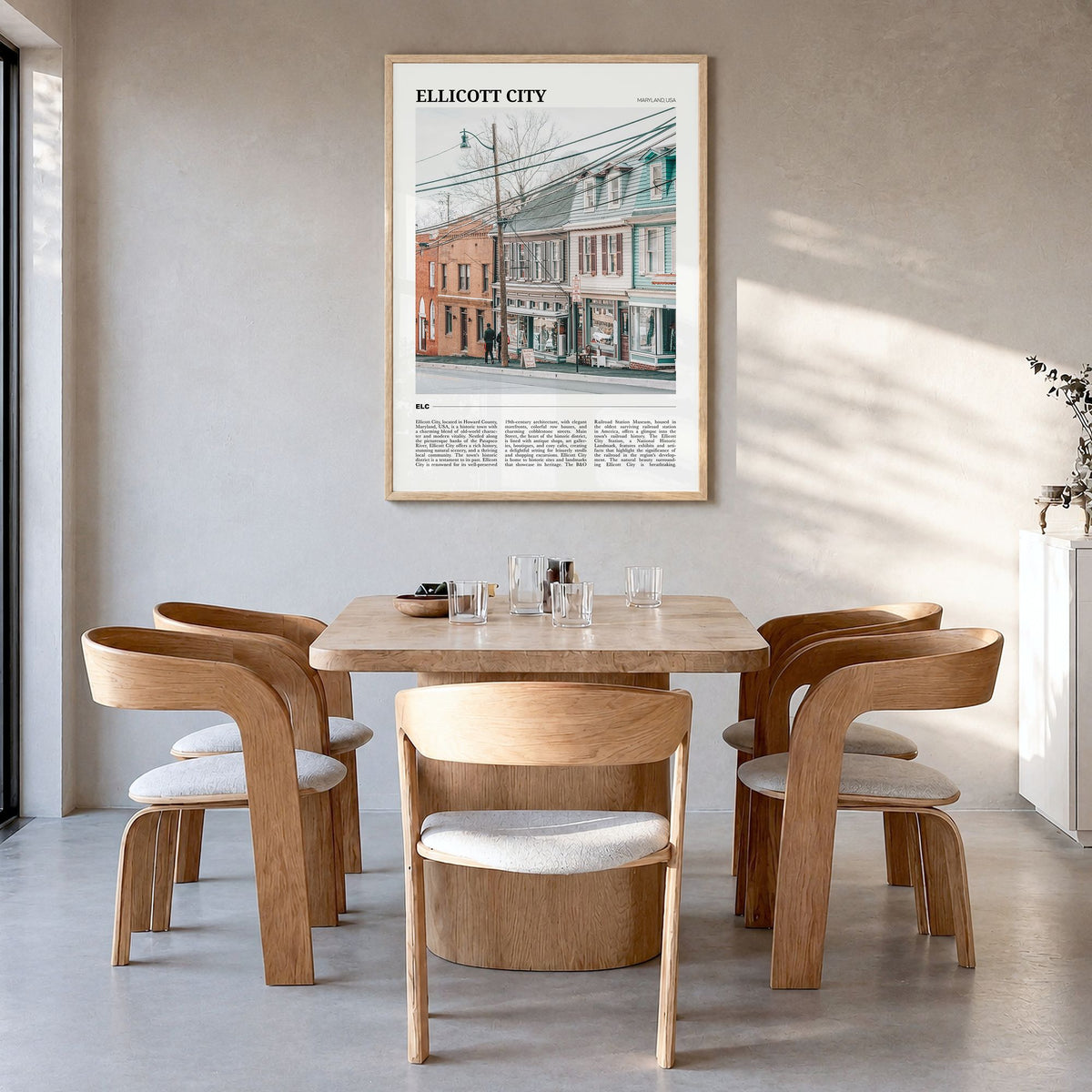 Ellicott City Travel Poster in a natural wood frame, hanging in a dining room