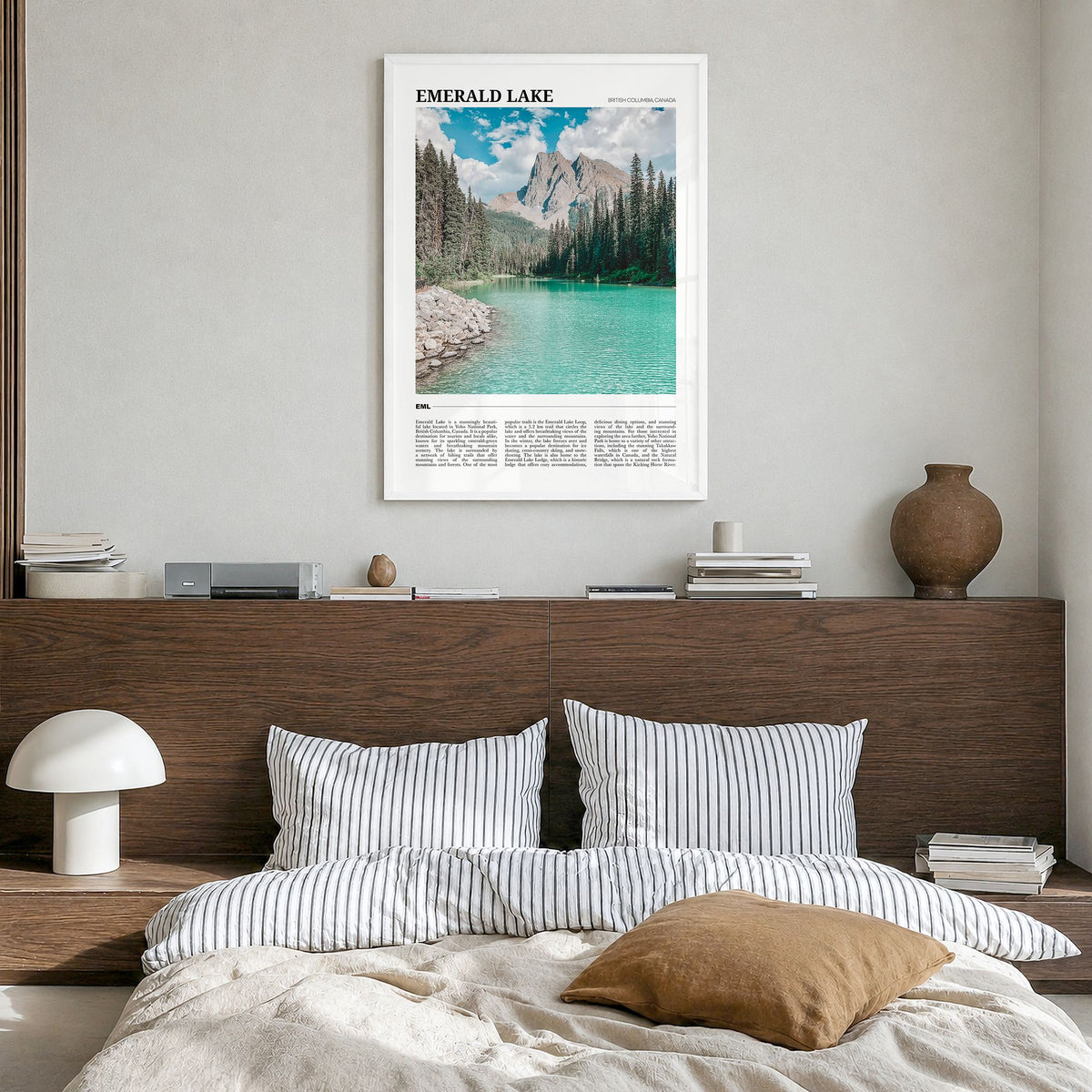 Emerald Lake Travel Poster in a white wood frame, hanging in a bedroom
