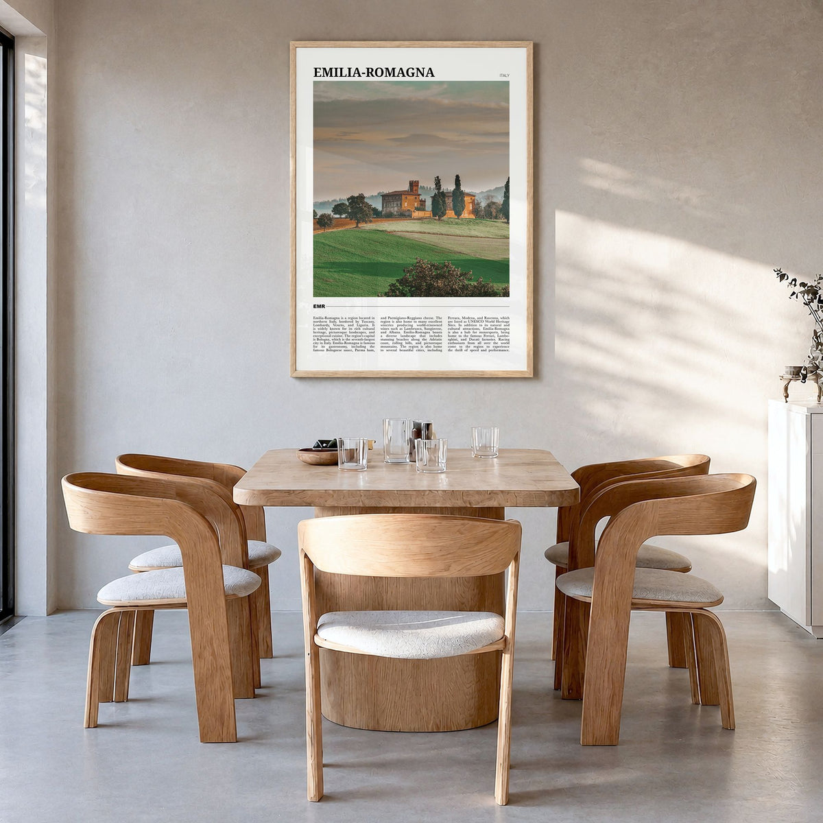 Emilia-Romagna Travel Poster in a natural wood frame, hanging in a dining room