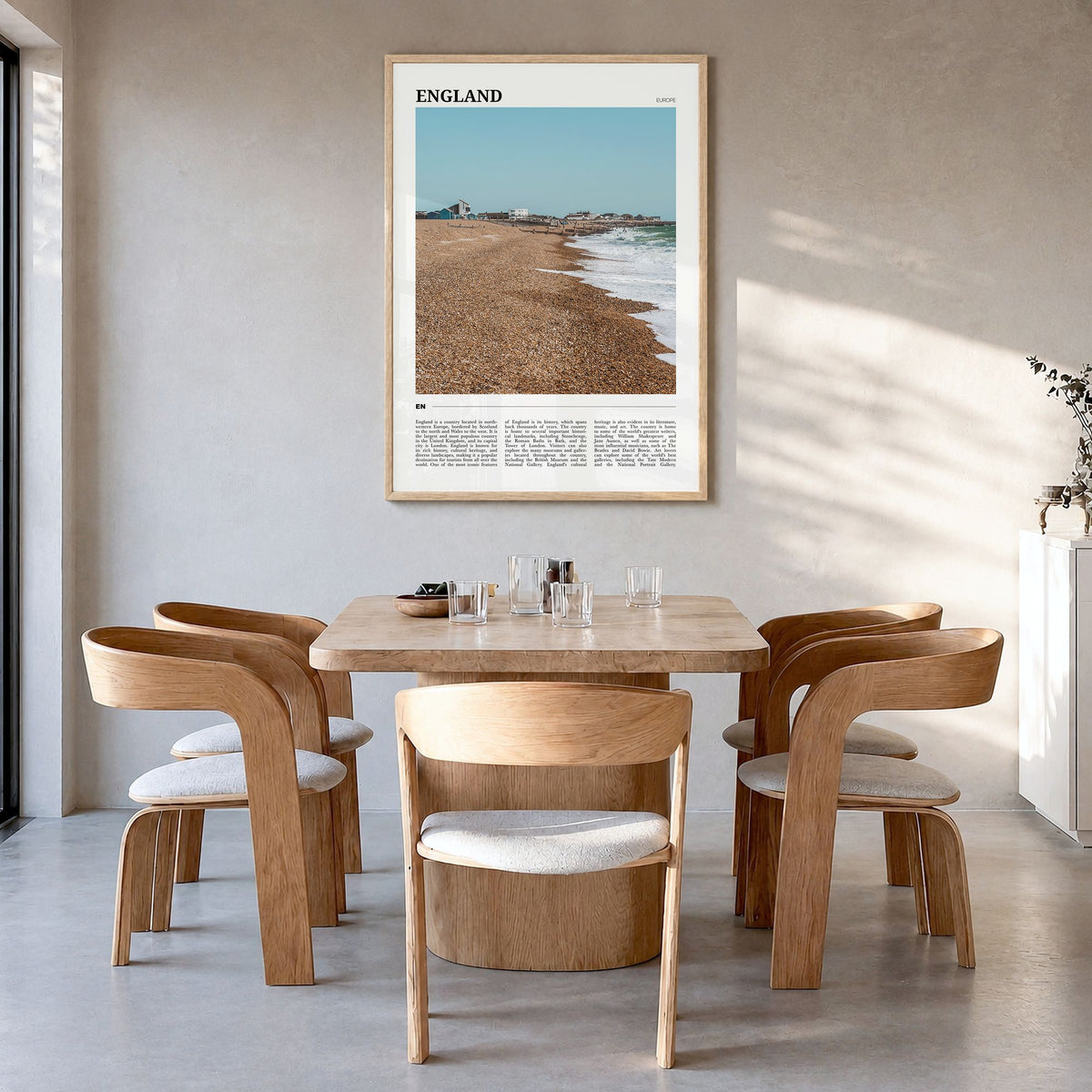 England Travel Poster in a natural wood frame, hanging in a dining room
