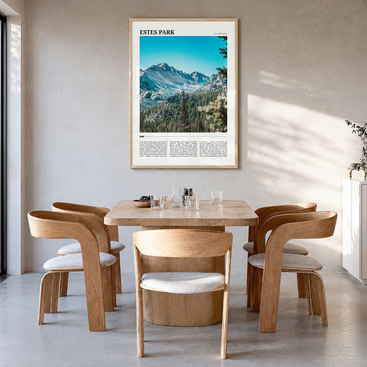 Estes Park Travel Poster in a natural wood frame, hanging in a dining room