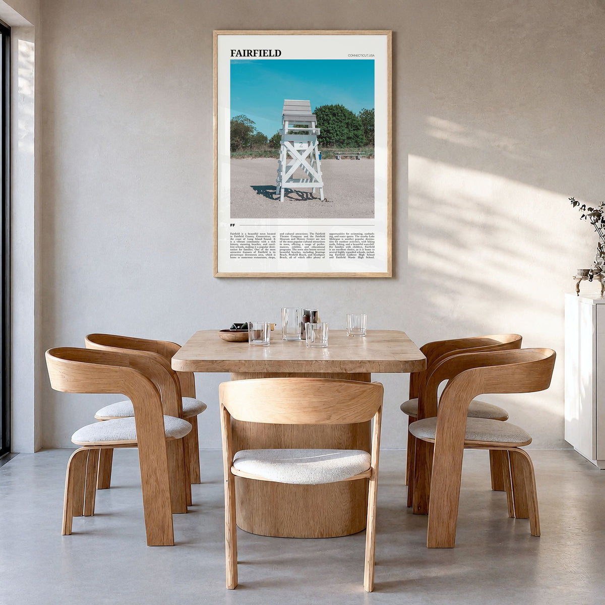 Fairfield Travel Poster in a natural wood frame, hanging in a dining room