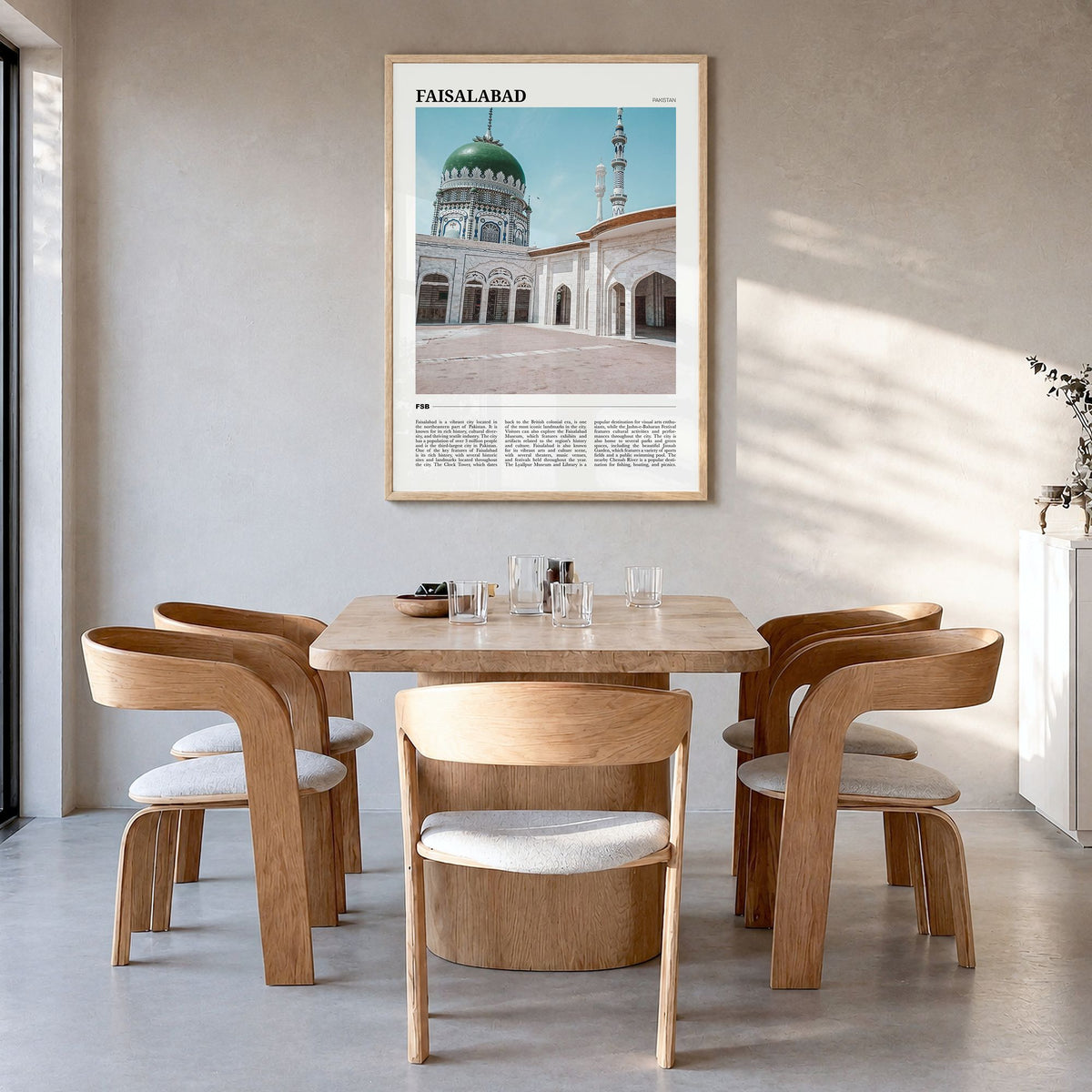 Faisalabad Travel Poster in a natural wood frame, hanging in a dining room