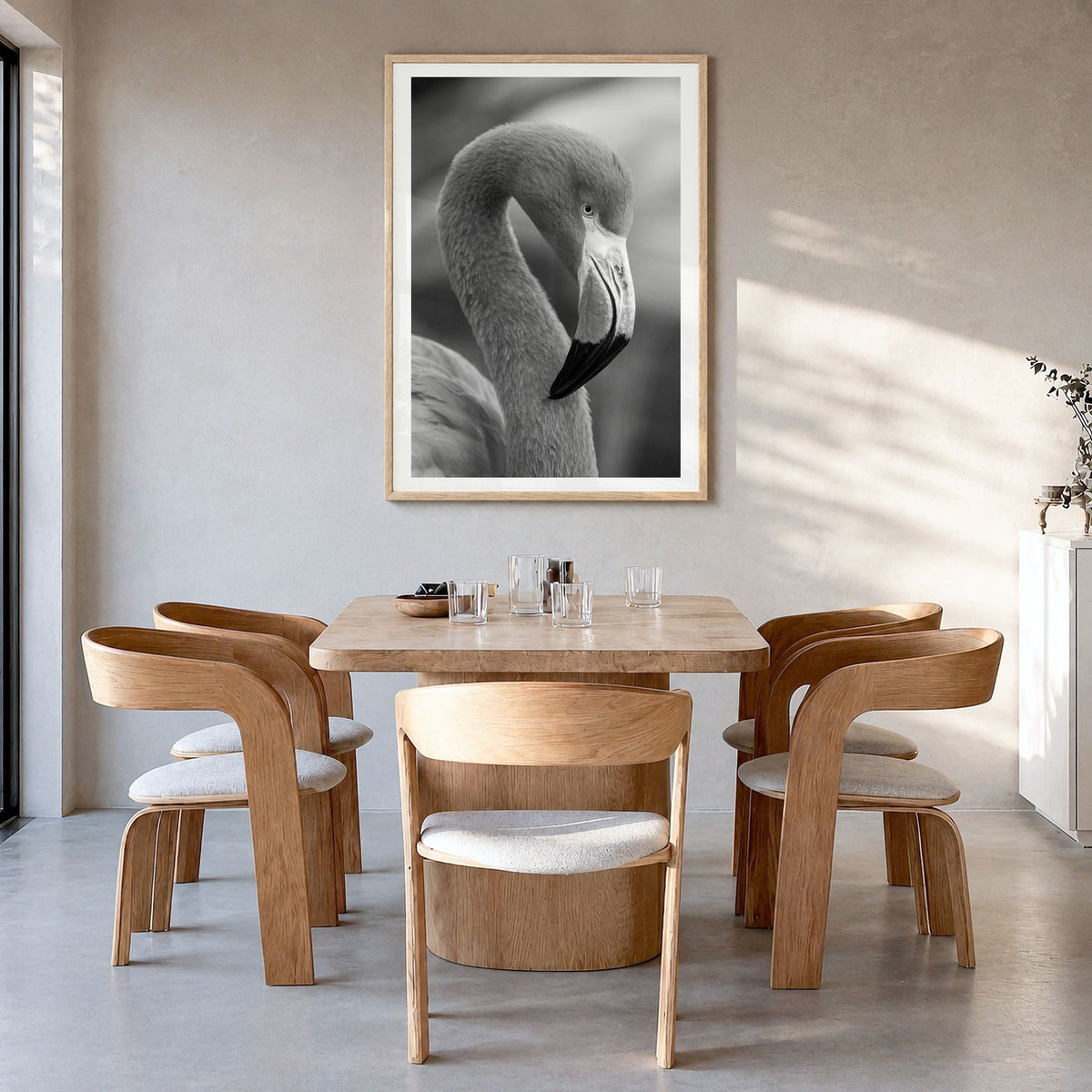 Flamingo Photo Poster in a natural wood frame, hanging in a dining room, white border