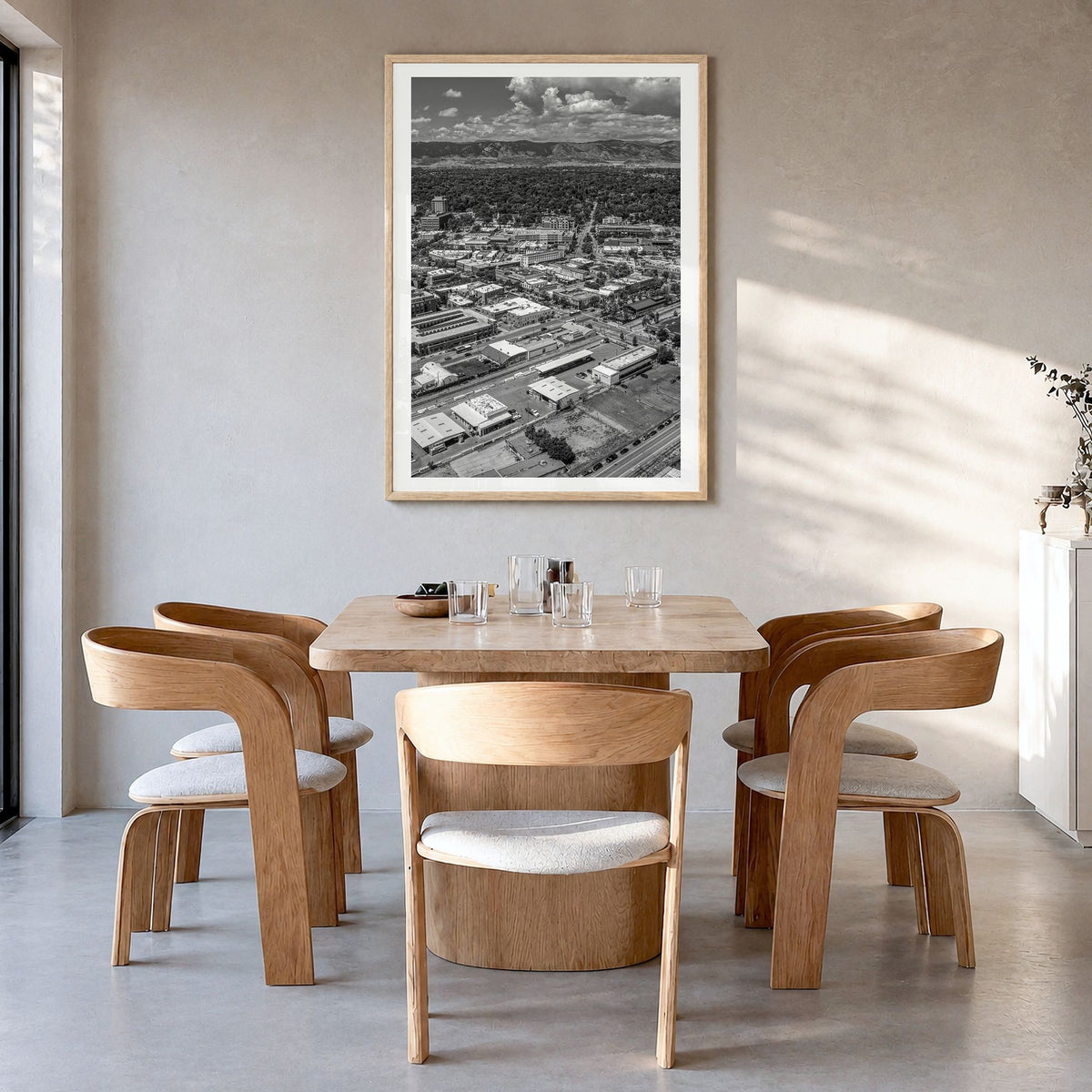Fort Collins Photo Poster in a natural wood frame, hanging in a dining room, white border