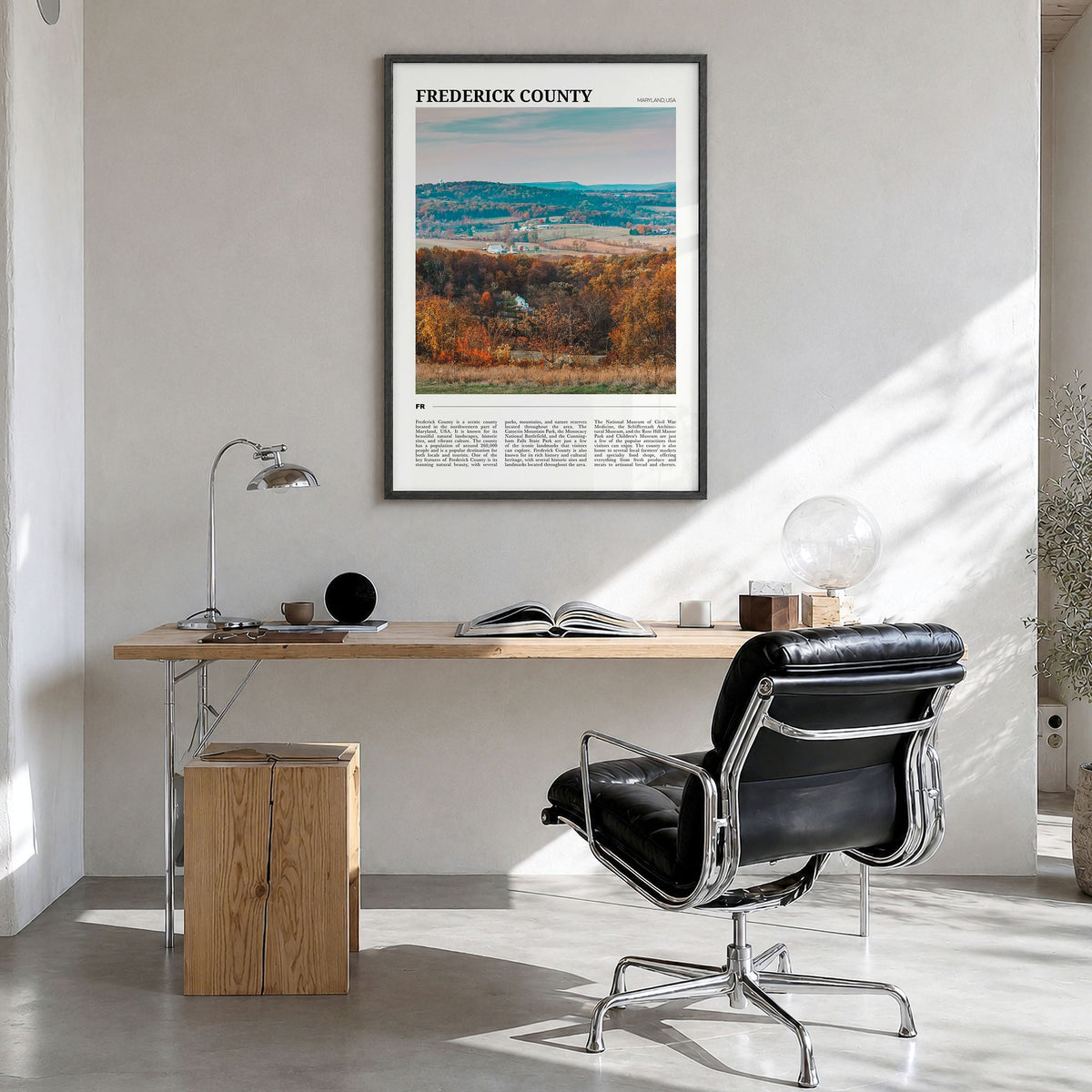 Frederick County Travel Poster in a black wood frame, hanging in a bright home office