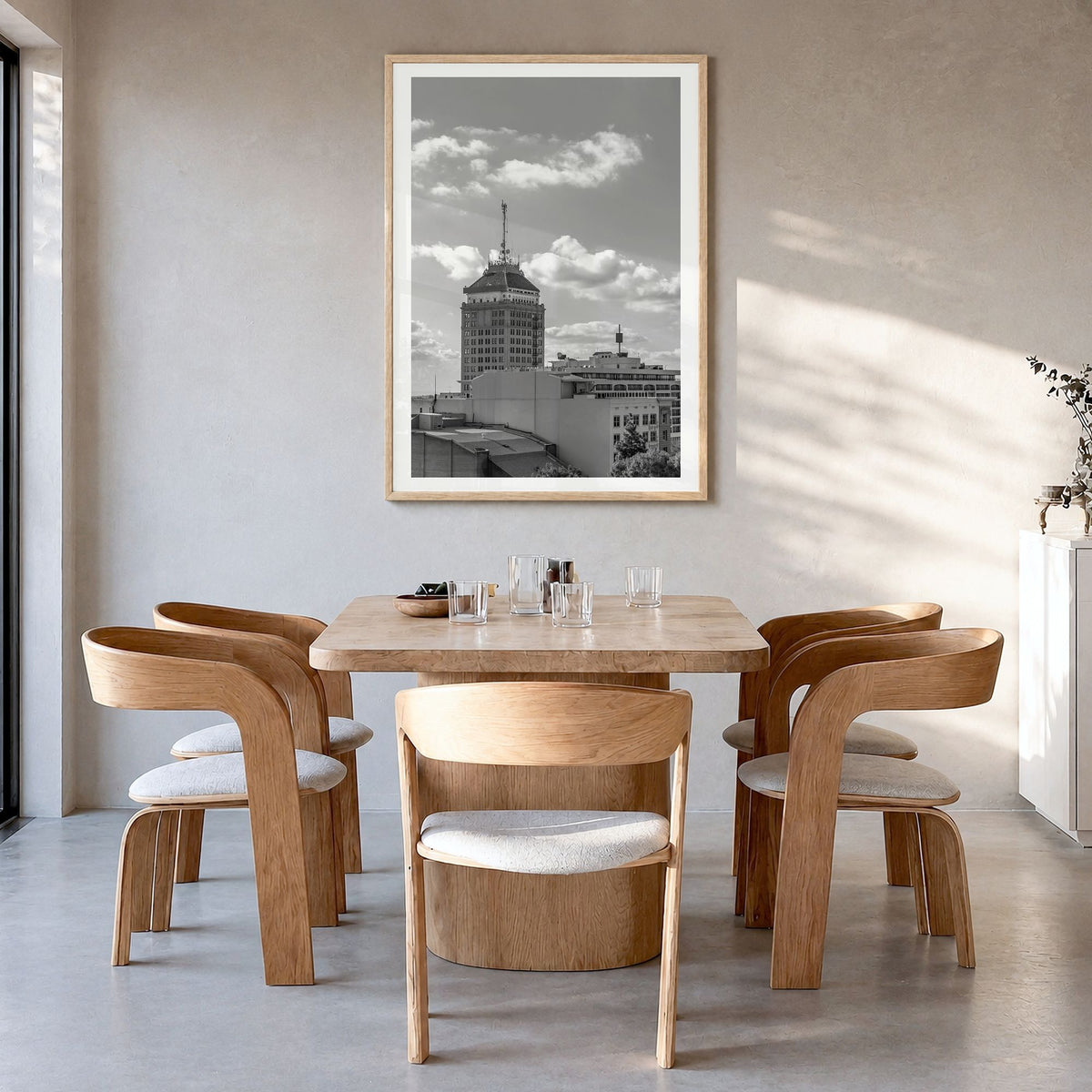 Fresno Photo Poster in a natural wood frame, hanging in a dining room, white border