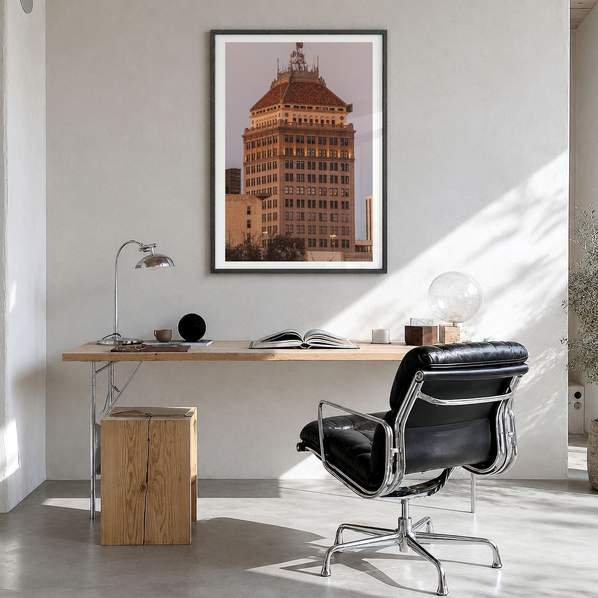 Fresno Photo Poster in a black wood frame, hanging in a bright home office, white border