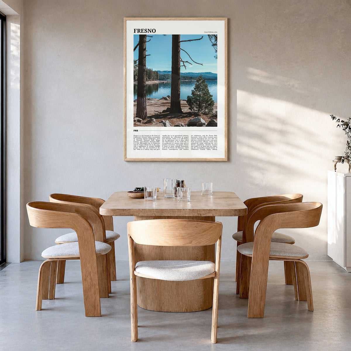 Fresno Travel Poster in a natural wood frame, hanging in a dining room