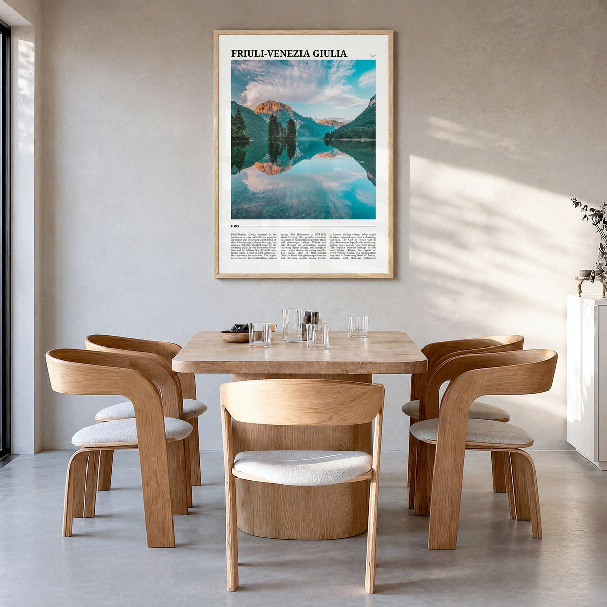 Friuli-Venezia Giulia Travel Poster in a natural wood frame, hanging in a dining room