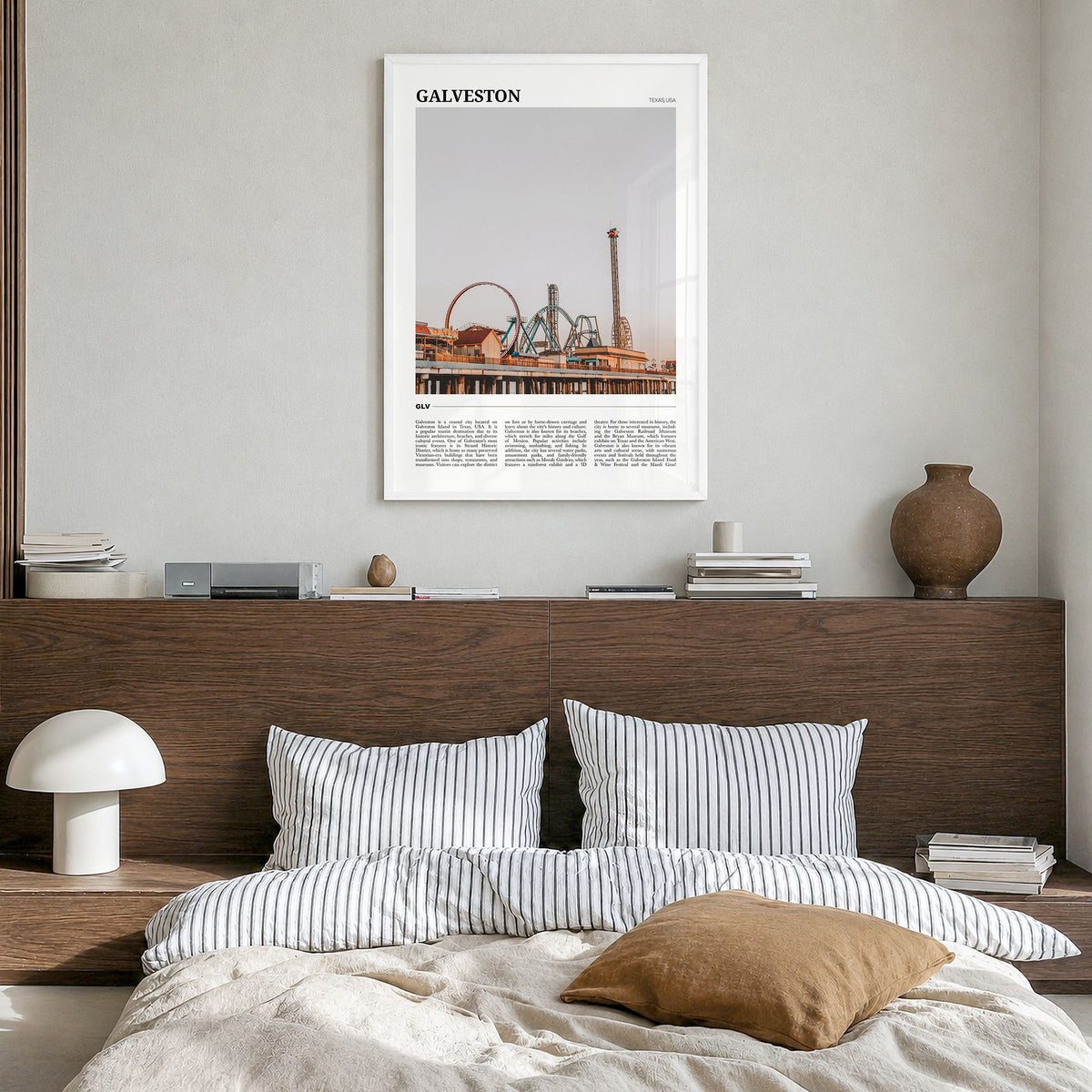 Galveston Travel Poster in a white wood frame, hanging in a bedroom