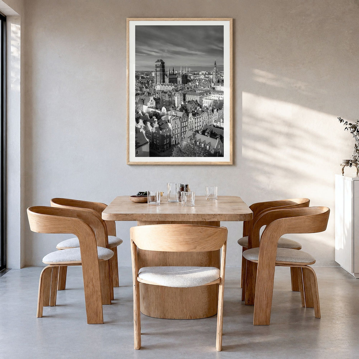 Gdańsk Photo Poster in a natural wood frame, hanging in a dining room, white border