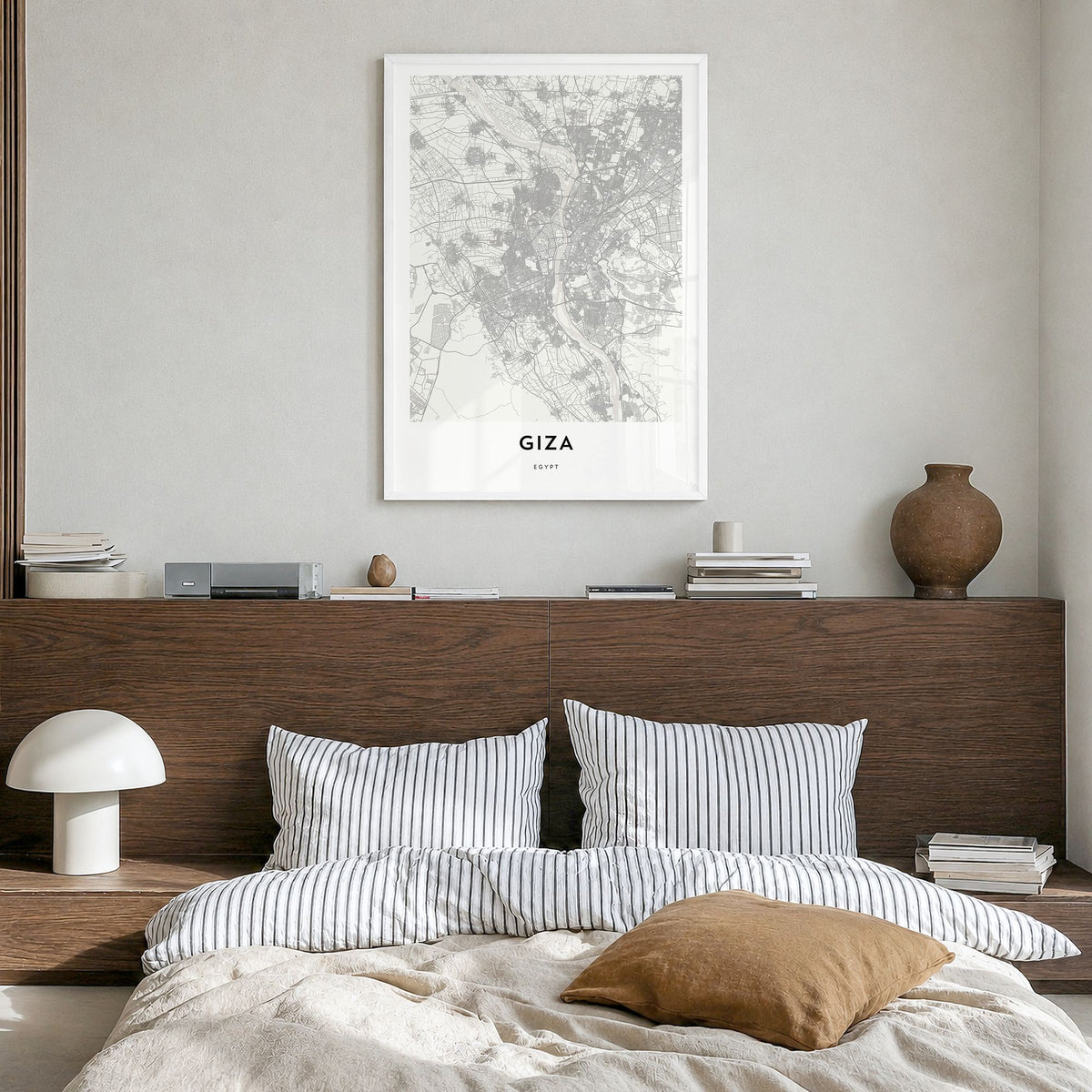 Giza Map Poster in a white wood frame, hanging in a bedroom