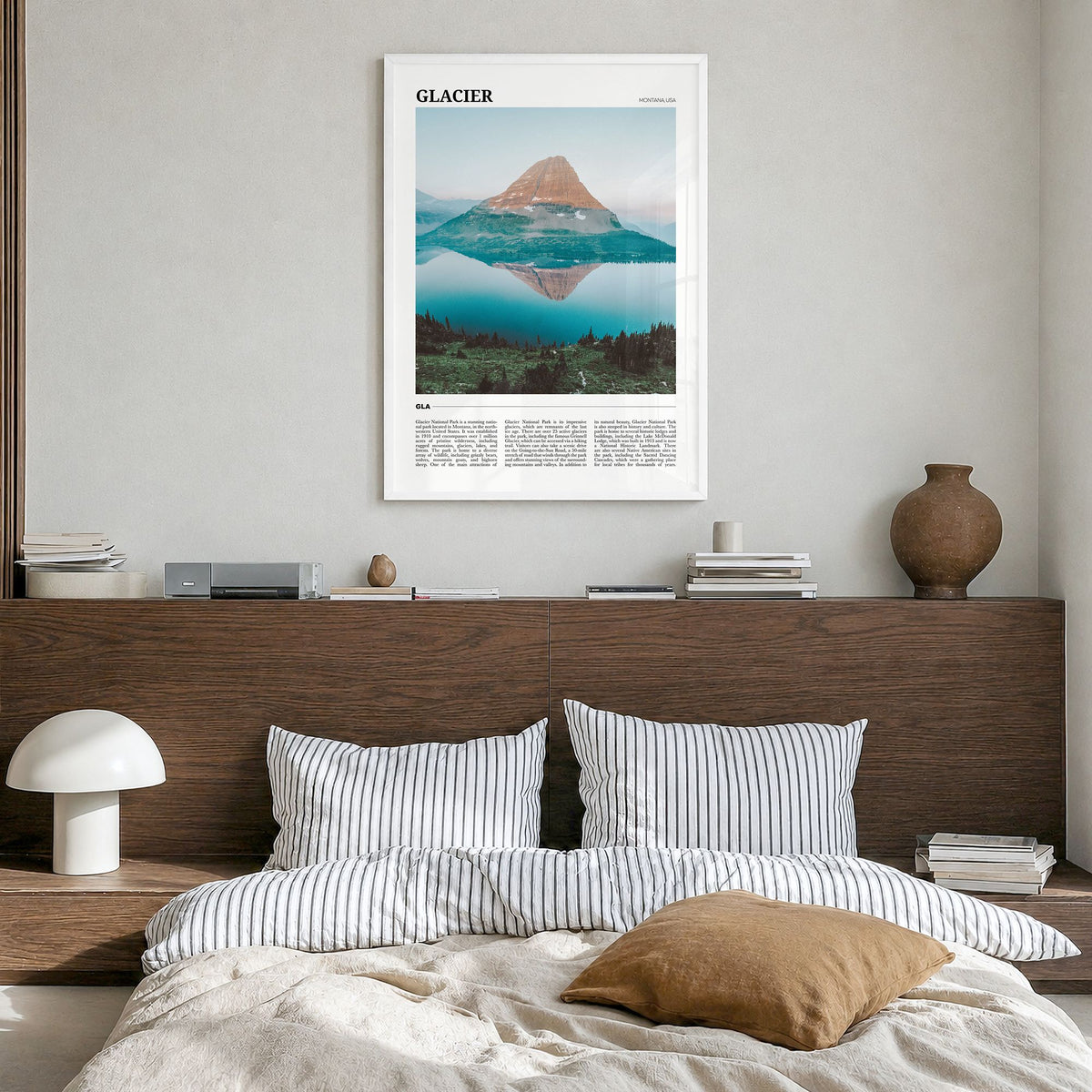 Glacier National Park Travel Poster in a white wood frame, hanging in a bedroom