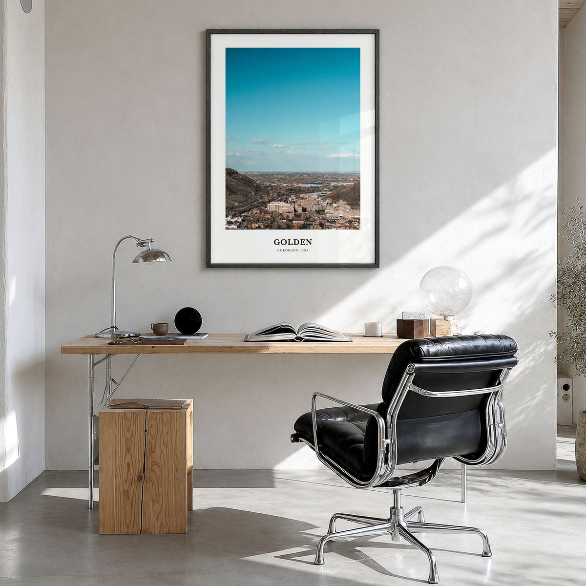 Golden Classic Poster in a black wood frame, hanging in a bright home office