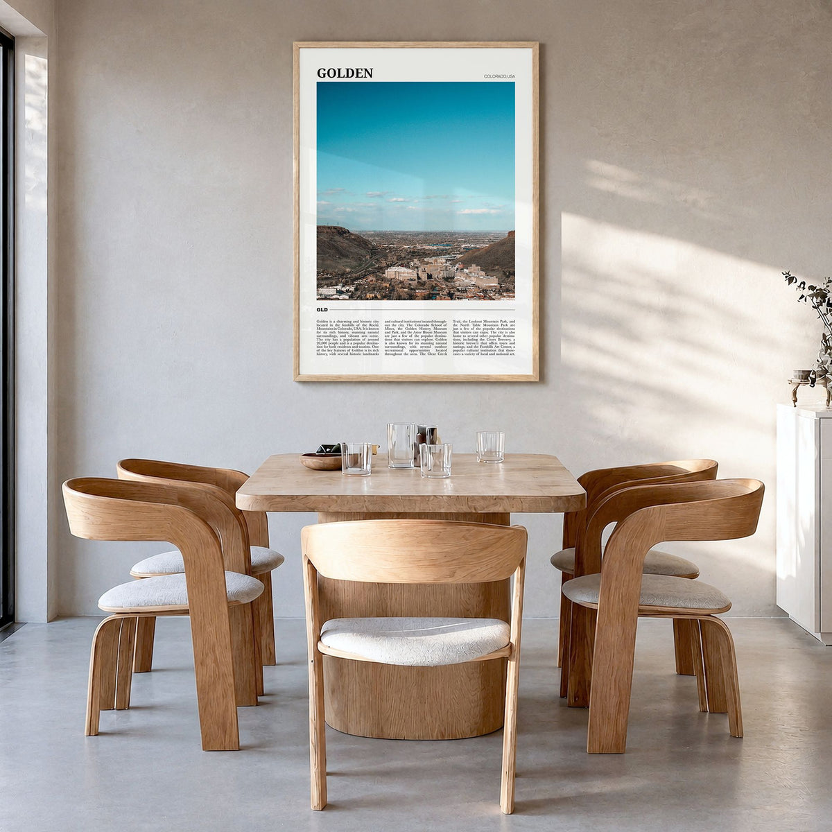 Golden Travel Poster in a natural wood frame, hanging in a dining room