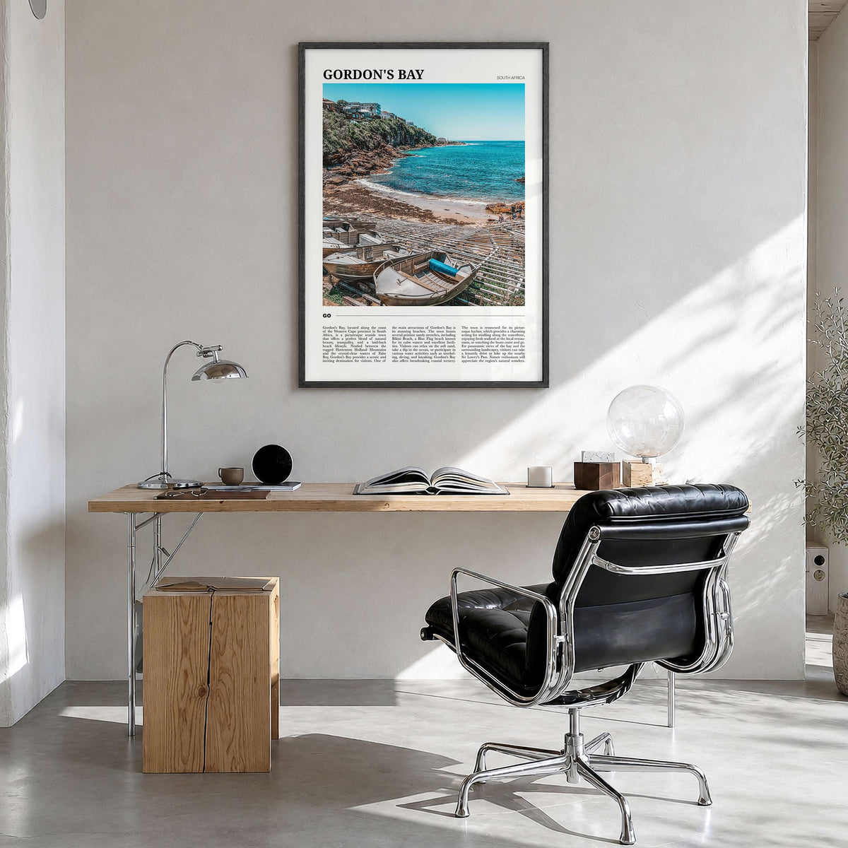 Gordon's Bay Travel Poster in a black wood frame, hanging in a bright home office