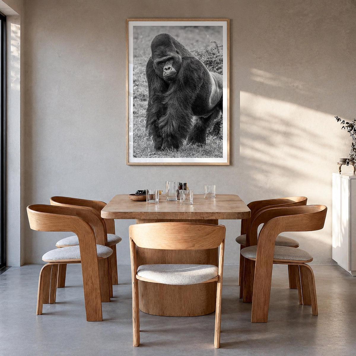 Gorilla black & white photo poster – vertical wall art in natural wood frame with white border, hanging on wall