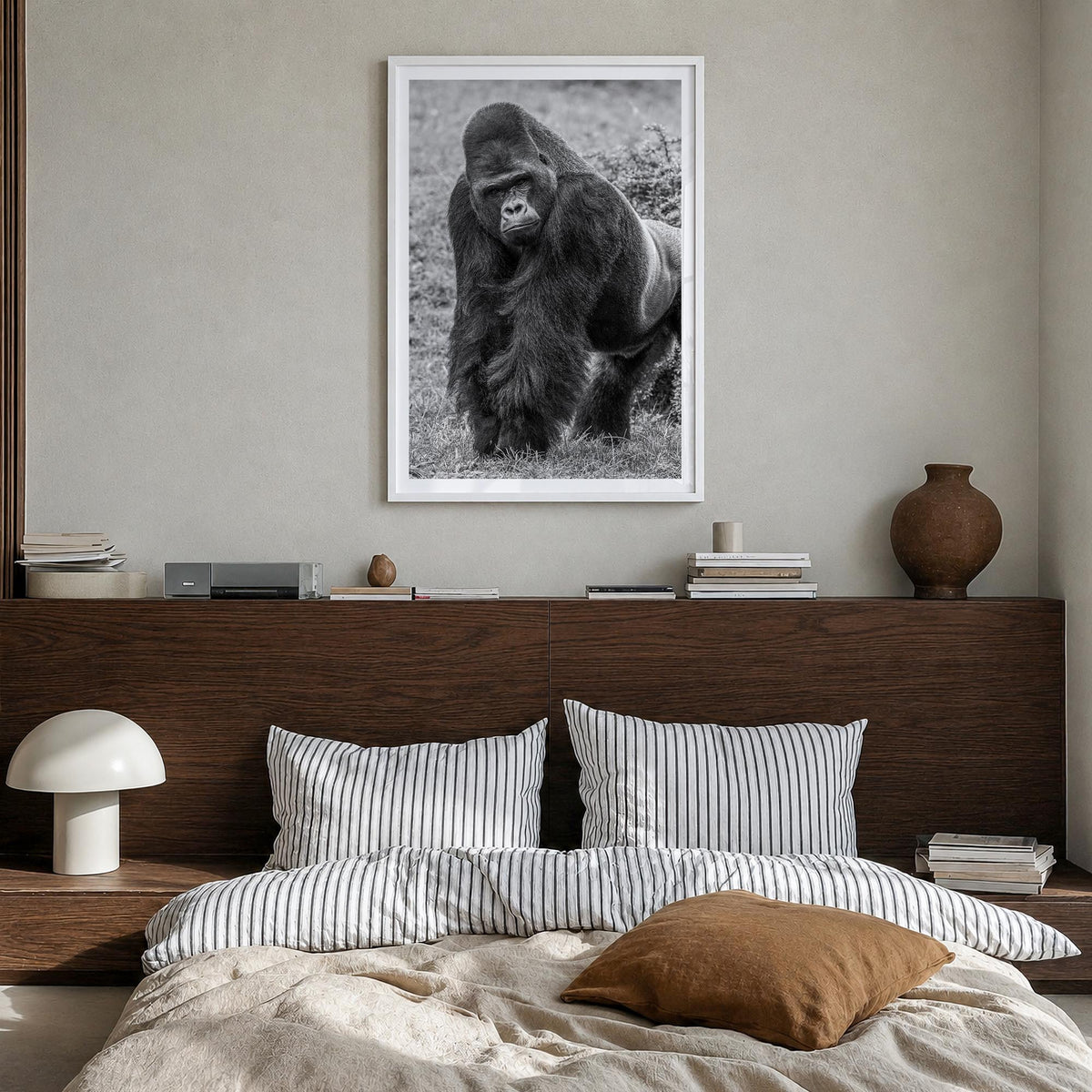 Gorilla black & white photo poster – vertical wall art in white wood frame with white border, hanging on wall