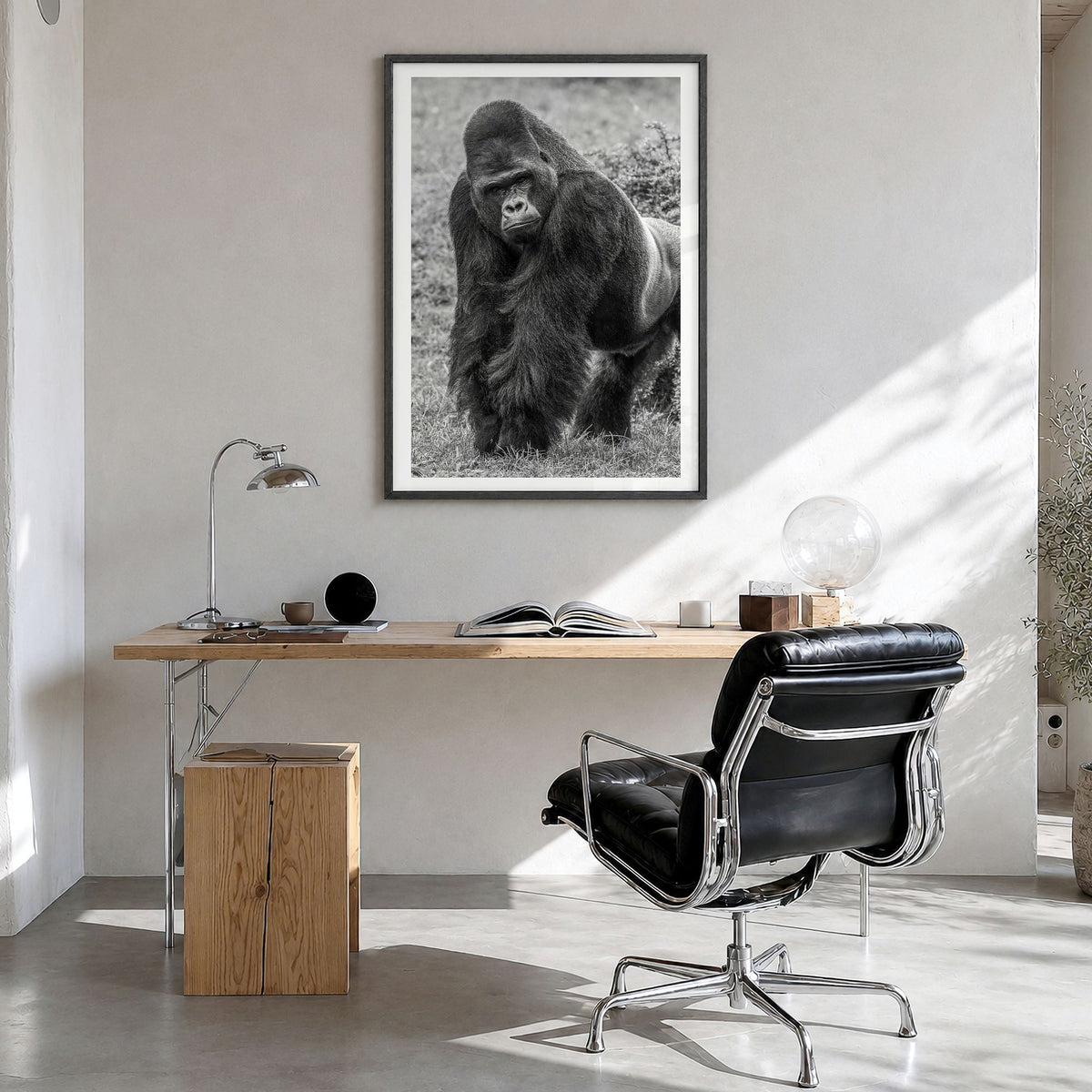 Gorilla Photo Poster in a black wood frame, hanging in a bright home office, white border