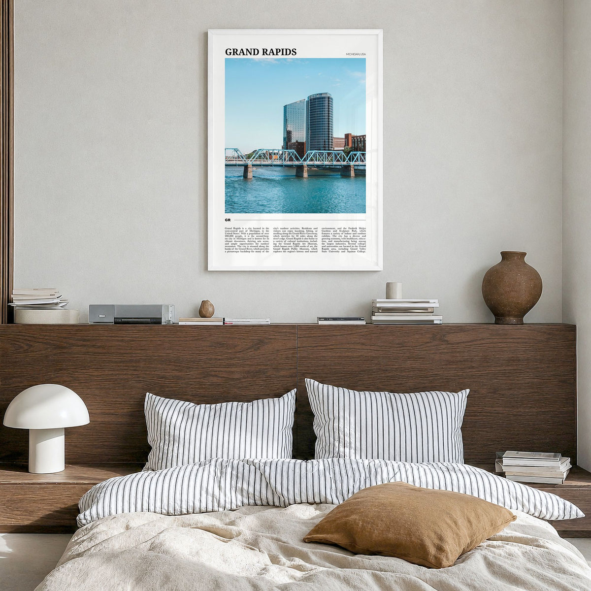 Grand Rapids Travel Poster in a white wood frame, hanging in a bedroom