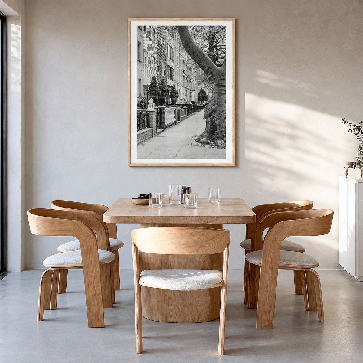 Greenpoint Photo Poster in a natural wood frame, hanging in a dining room, white border
