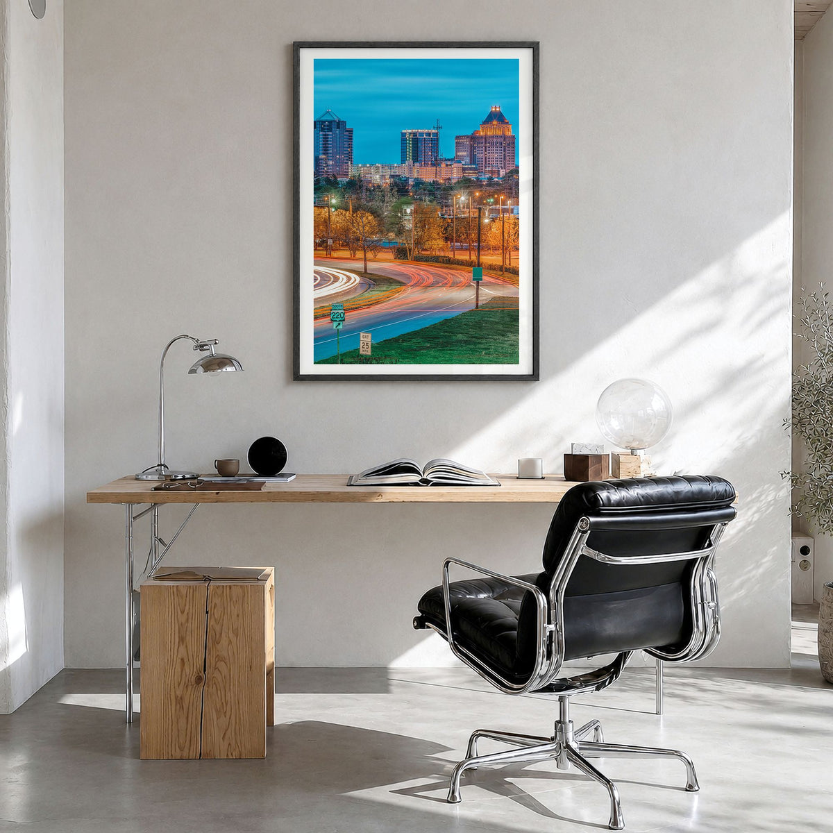 Greensboro Photo Poster in a black wood frame, hanging in a bright home office, white border