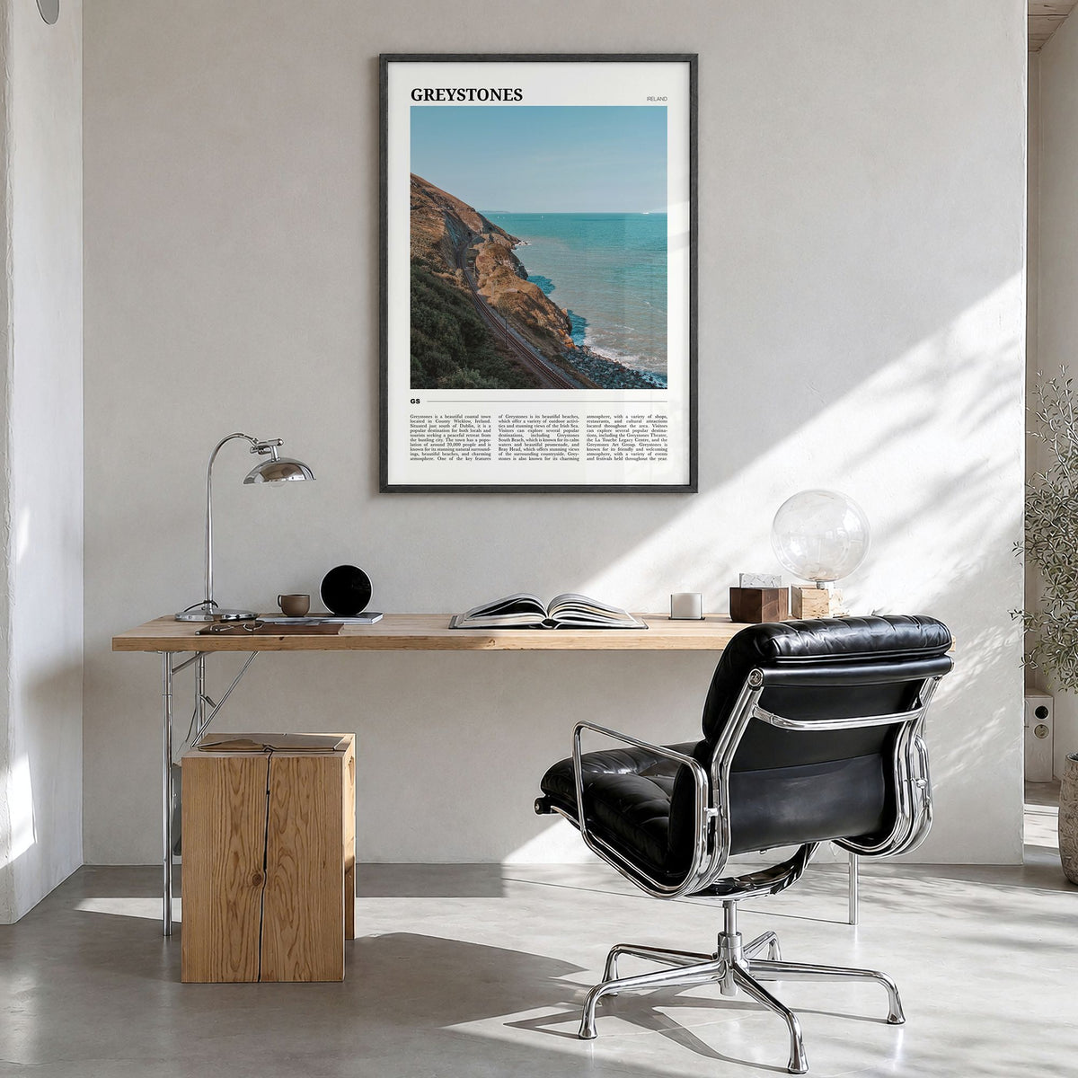Greystones Travel Poster in a black wood frame, hanging in a bright home office