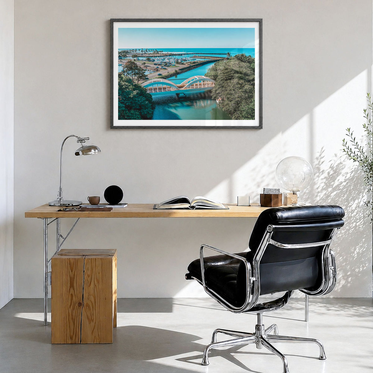 Haleiwa Photo Poster in a black wood frame, hanging in a bright home office, white border