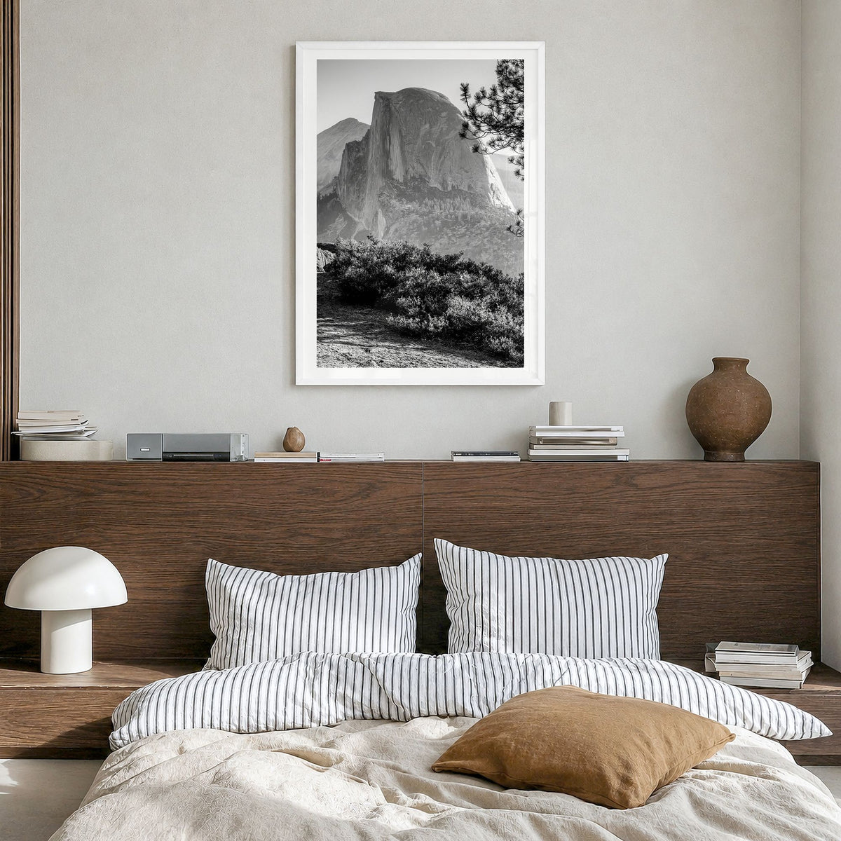 Half Dome Photo Poster in a white wood frame, hanging in a bedroom, white border