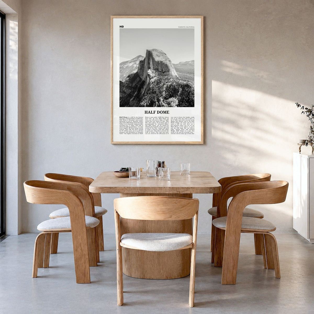 Half Dome Newspaper Poster in a natural wood frame, hanging in a dining room