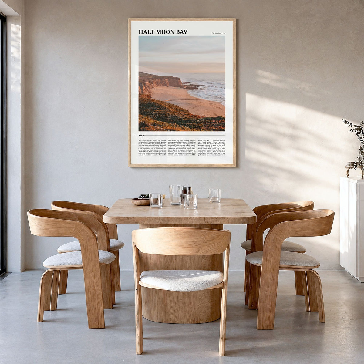 Half Moon Bay Travel No 1 Poster in a natural wood frame, hanging in a dining room